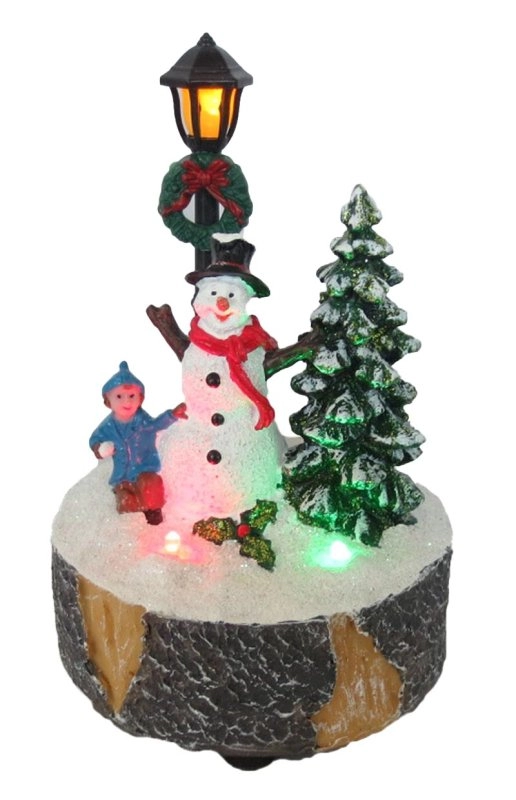 Bâtiment de Noël illuminé Bonhomme de neige, combat de boules de neige et village de chorales