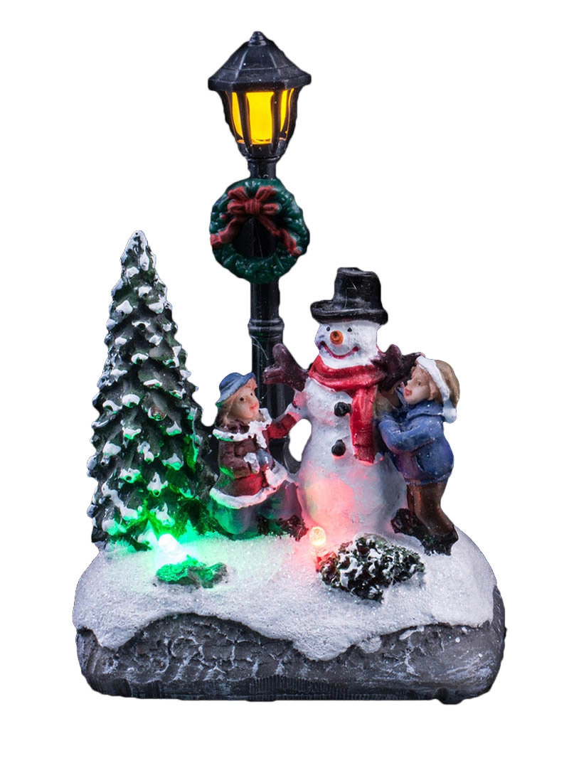 Scène de Noël illuminée avec des enfants décorant le bonhomme de neige