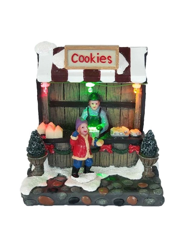 Boutique de biscuits de Noël illuminés avec garçon
